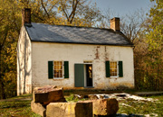 Lockhouse 25 is a small white house on the towpath with two front windows on either side of the front door