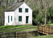 Lockhouse 28 is a two story white house on the towpath. This picture shows the bridge leading to it over the canal.