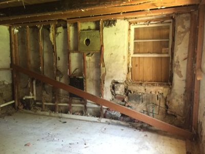 Post-demo: Downstream wall in kitchen, with water-damaged window base to right.