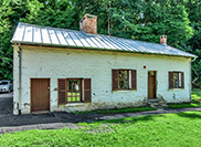 Lockhouse 21, "Swains Lockhouse", is a white house with a green lawn