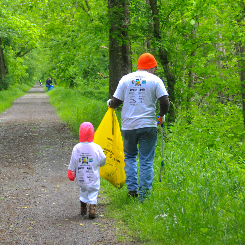 Parent and child pick up trash